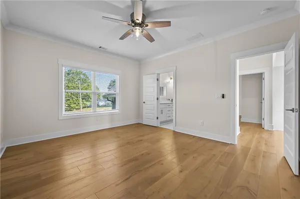 a view of an empty room with cabinet and a chandelier fan