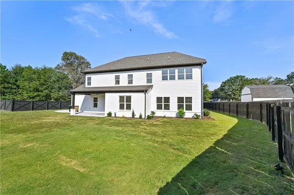 a bedroom with a bed and a ceiling fan