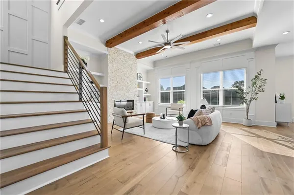 a living room with furniture a fireplace and a chandelier