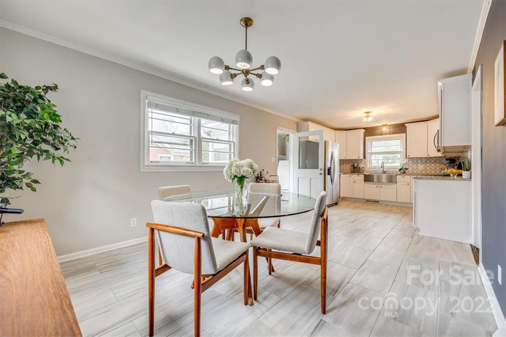 3537 Enfield Road Charlotte, NC 28205 - Photo 23 of 37 a view of a dining room with furniture window and wooden floor