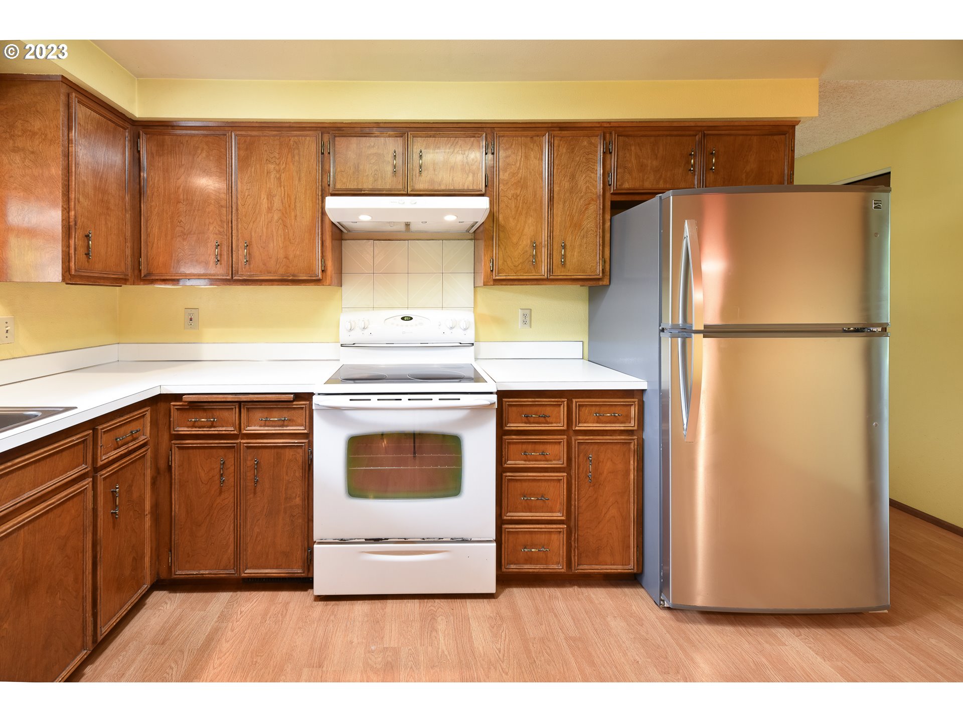 2466 Erin Way Eugene, OR 97408 - Photo 11 of 38 a kitchen with a refrigerator sink stove and cabinets