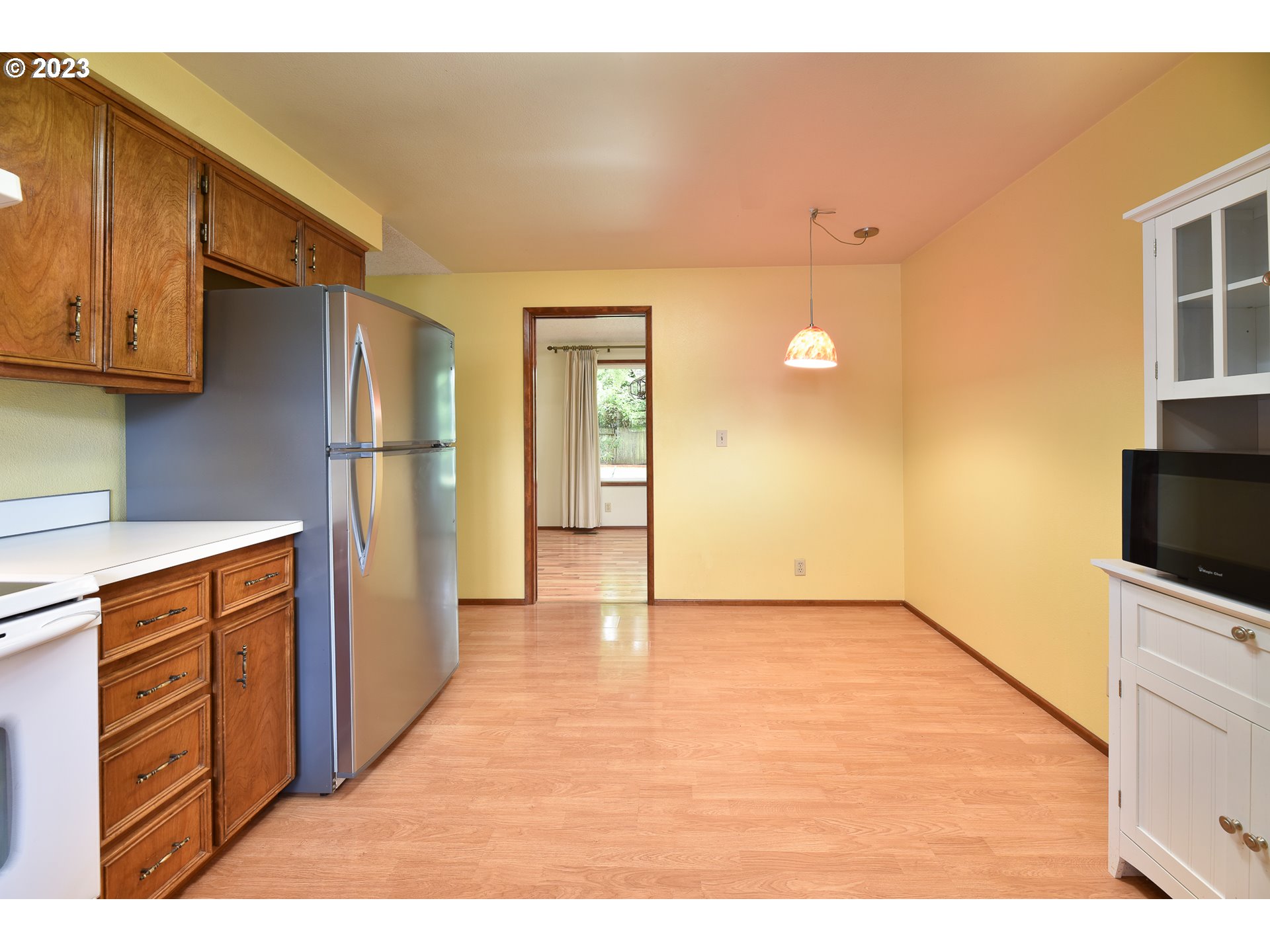 2466 Erin Way Eugene, OR 97408 - Photo 12 of 38 a view of a kitchen with wooden cabinets and a refrigerator