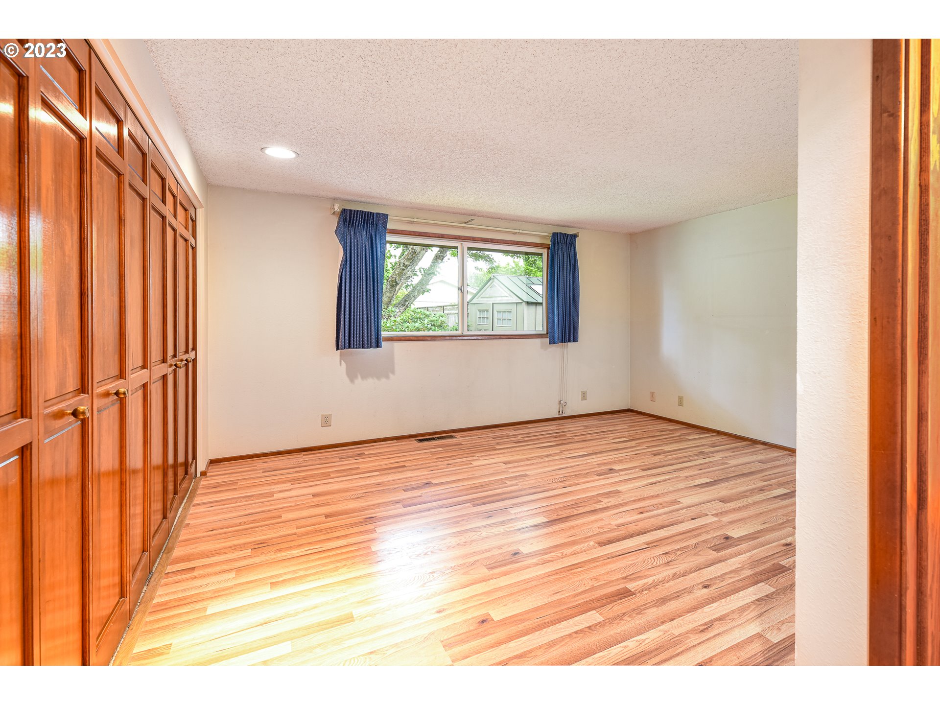 2466 Erin Way Eugene, OR 97408 - Photo 19 of 38 an empty room with wooden floor and windows
