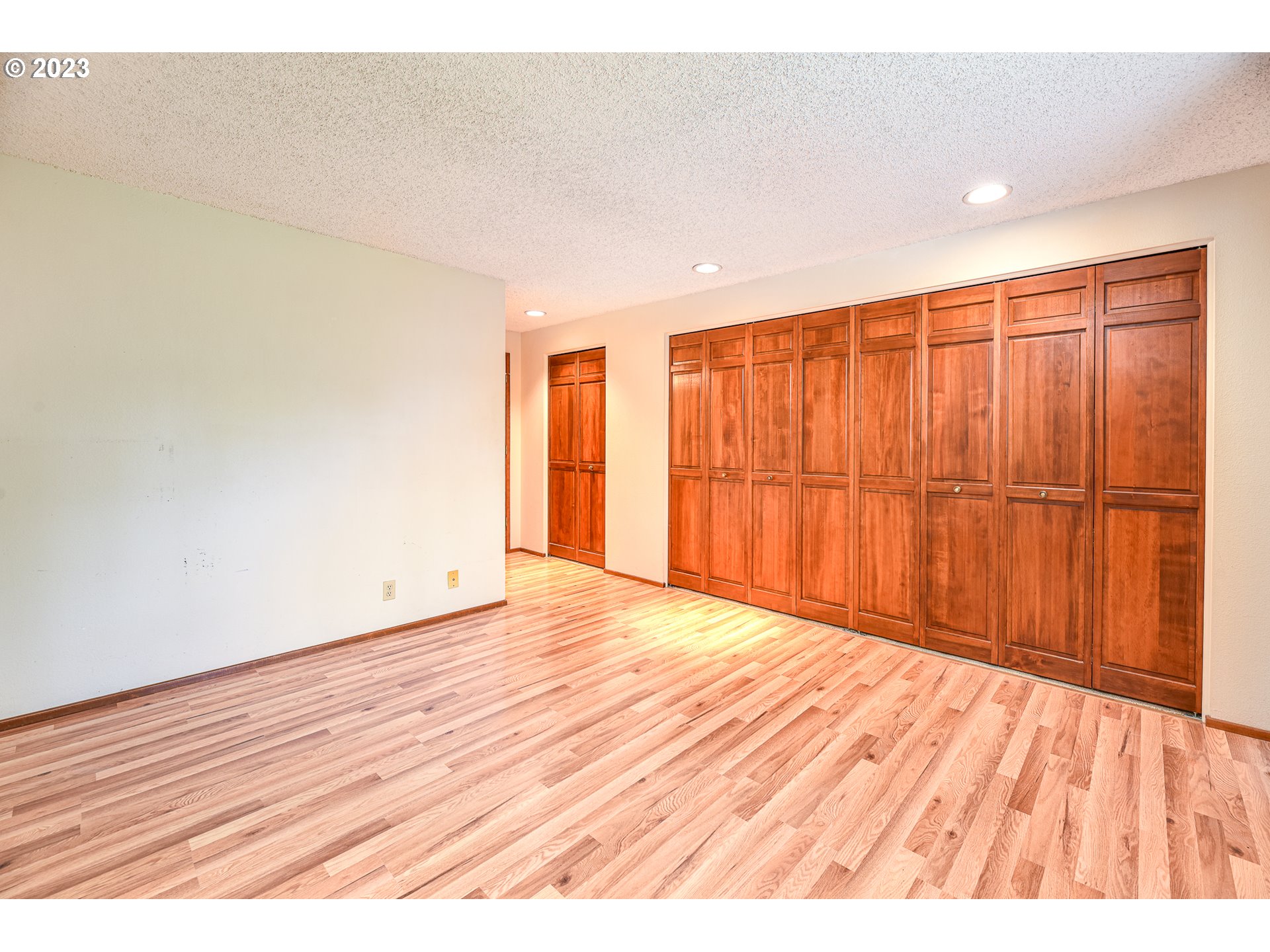 2466 Erin Way Eugene, OR 97408 - Photo 20 of 38 a view of an empty room with wooden floor