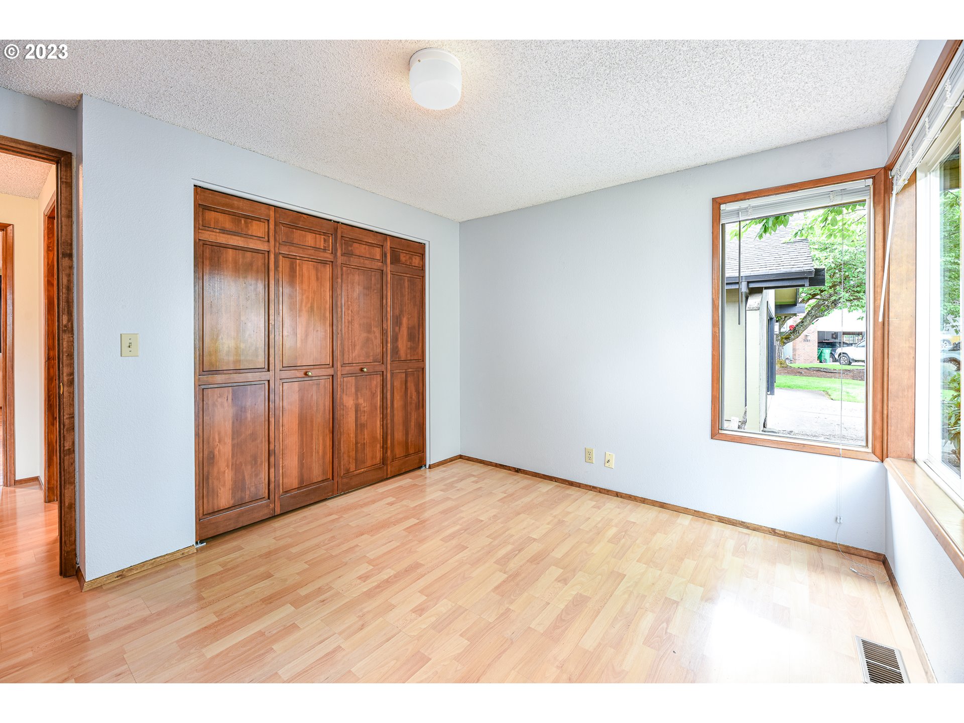 2466 Erin Way Eugene, OR 97408 - Photo 28 of 38 a view of an empty room with wooden floor and a window