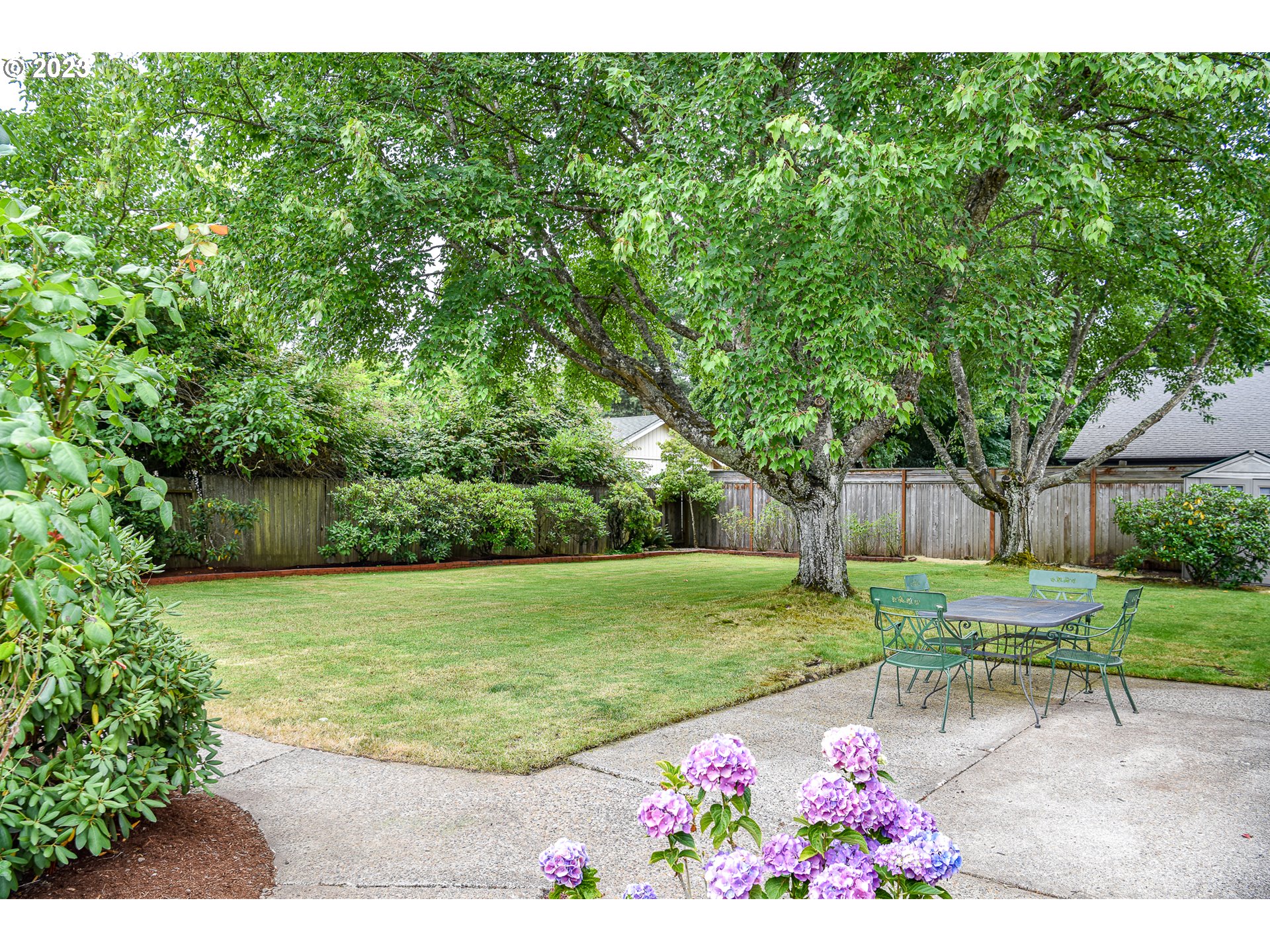 2466 Erin Way Eugene, OR 97408 - Photo 35 of 38 a view of a garden with flowers and trees