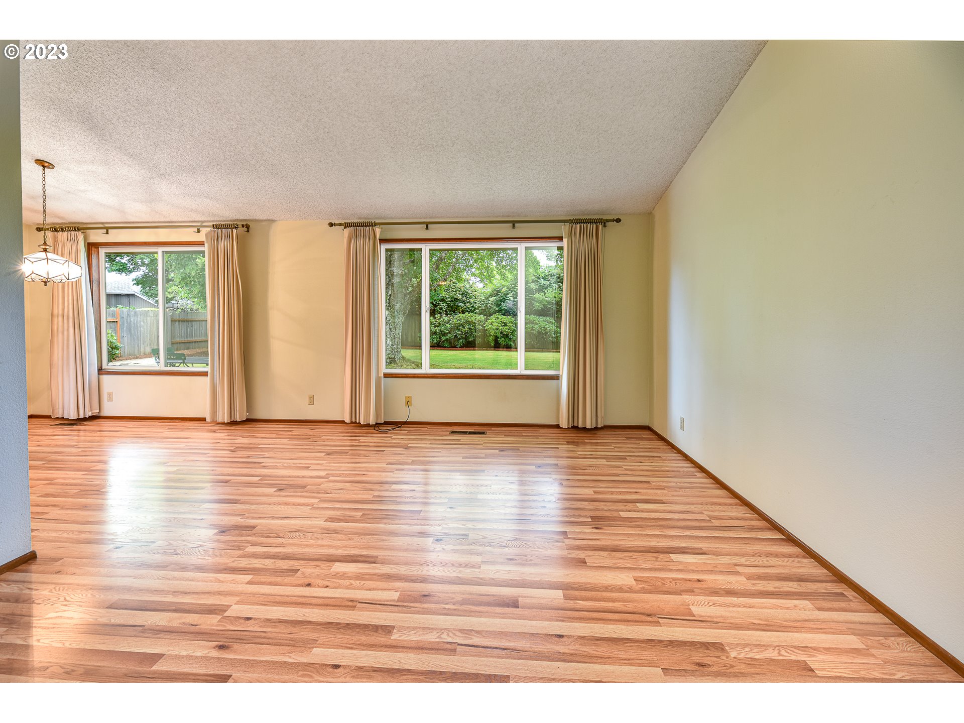2466 Erin Way Eugene, OR 97408 - Photo 5 of 38 a view of an empty room with wooden floor and a window