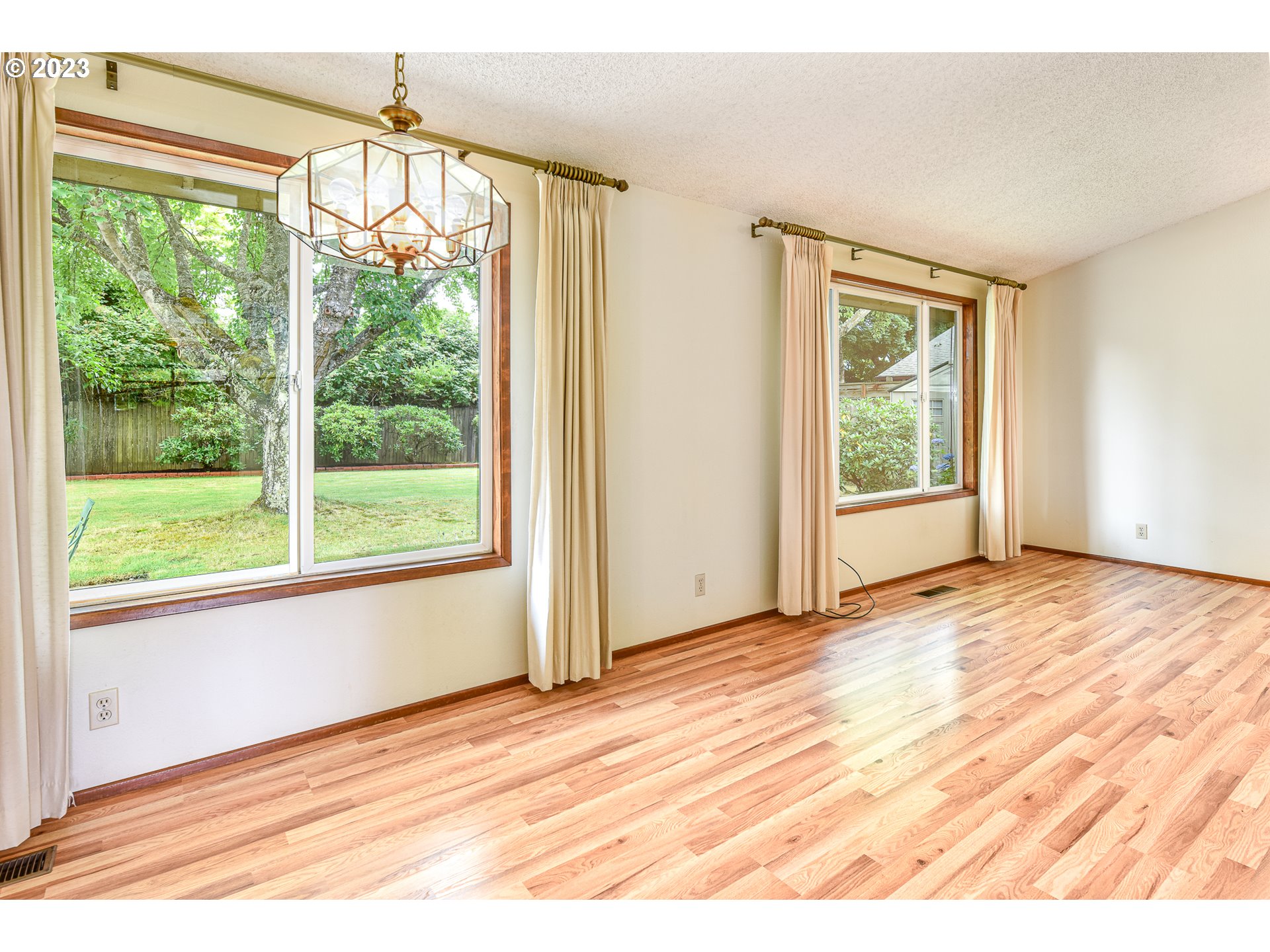 2466 Erin Way Eugene, OR 97408 - Photo 7 of 38 a view of an empty room with wooden floor and a window