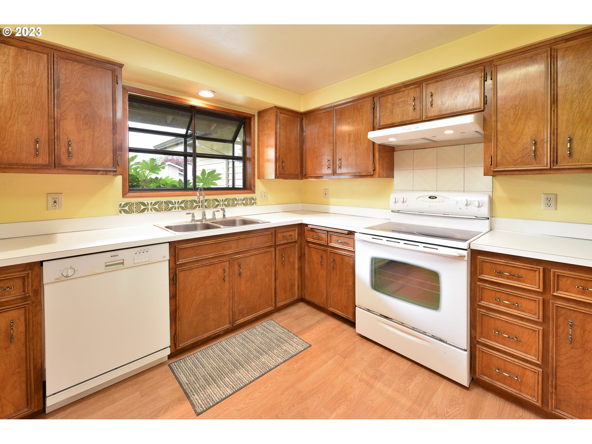 2466 Erin Way Eugene, OR 97408 - Photo 10 of 38 a kitchen with a stove sink and cabinets