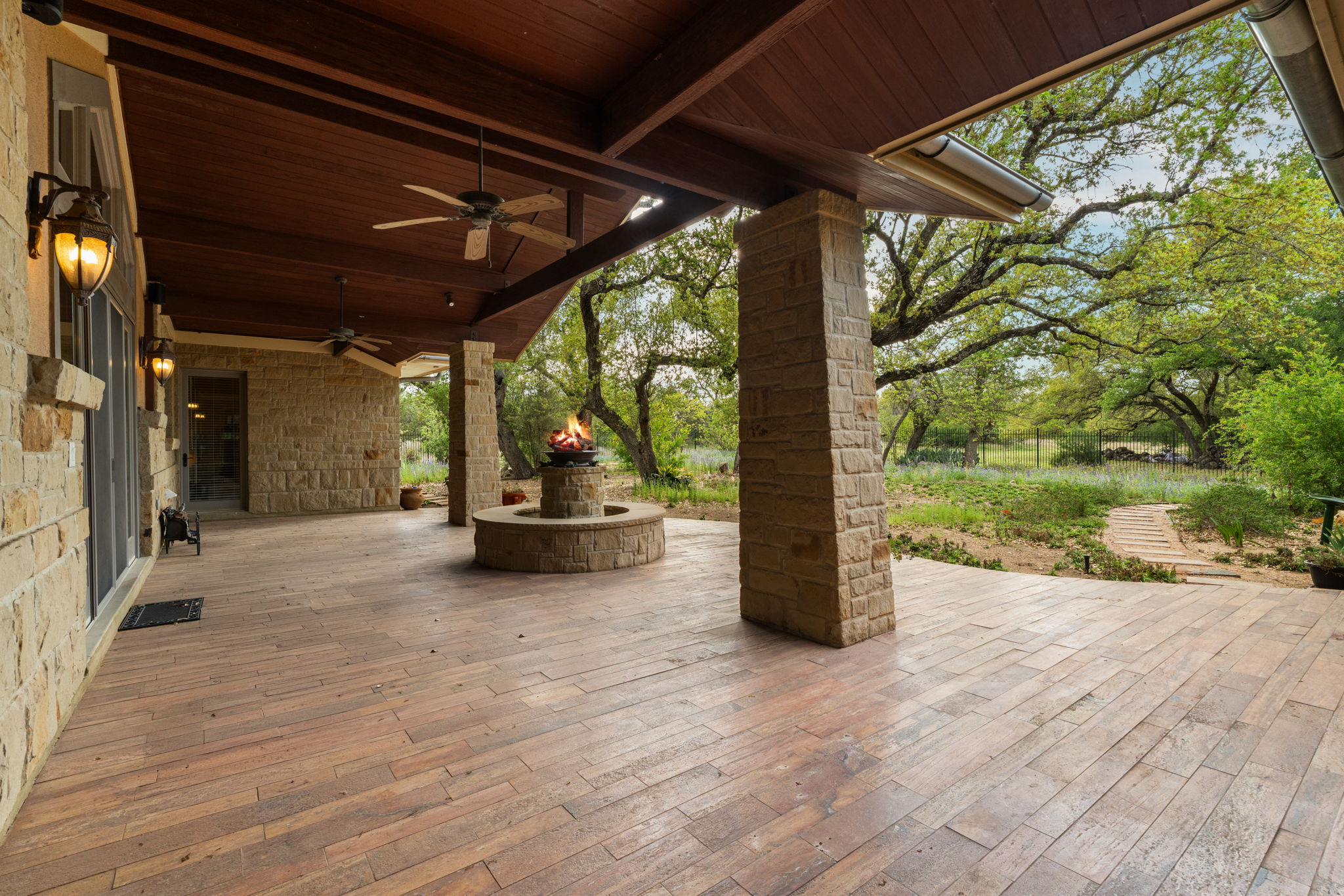 23426 Oscar Road Spicewood, TX 78669 - Photo 25 of 40 The covered patio is huge! The travertine floors extend to the patio. There is 1400 sw feet of outdoor entertaining area.