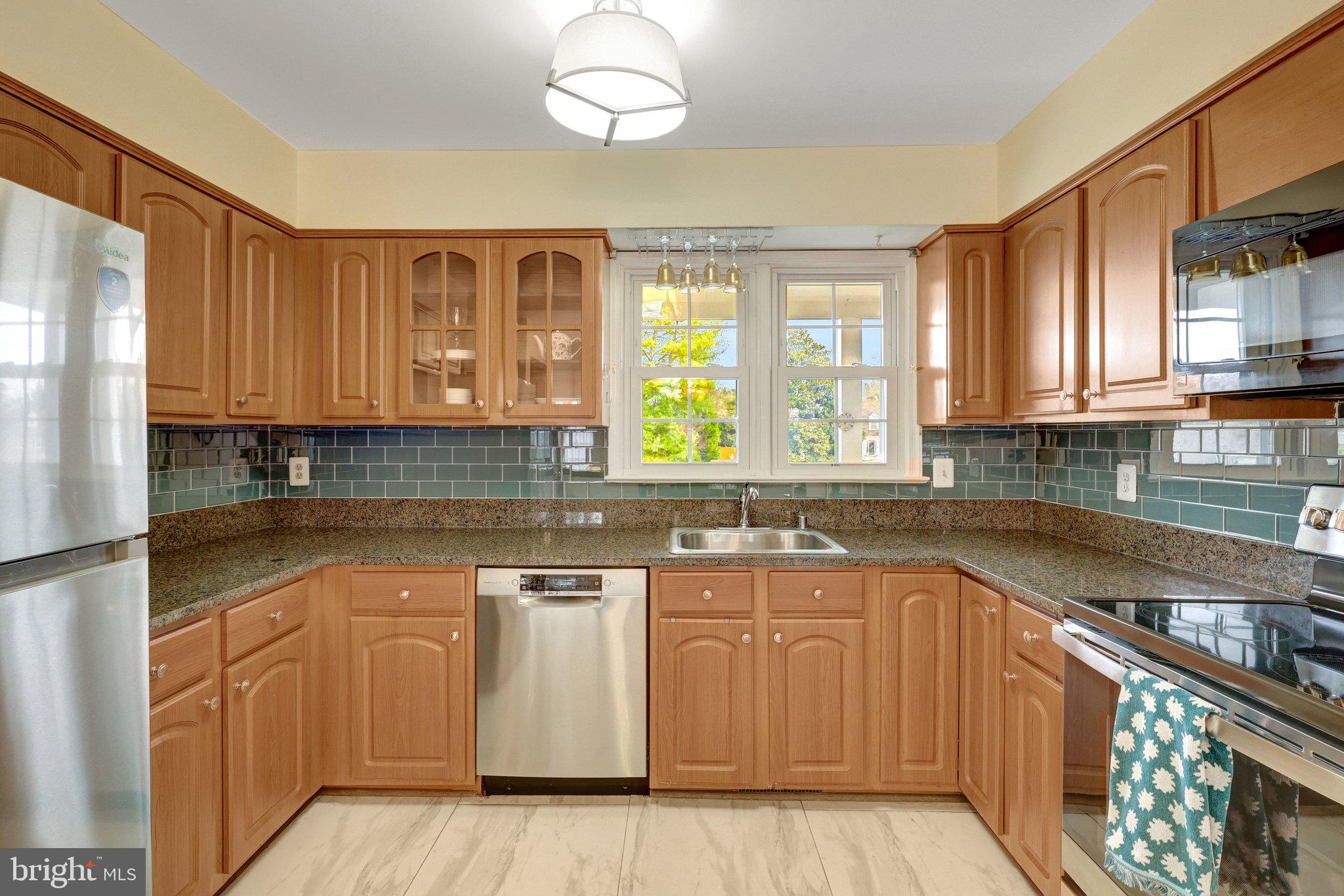 1398 Park Lake Drive Reston, VA 20190 - Photo 17 of 64 a kitchen with stainless steel appliances granite countertop a sink and cabinets