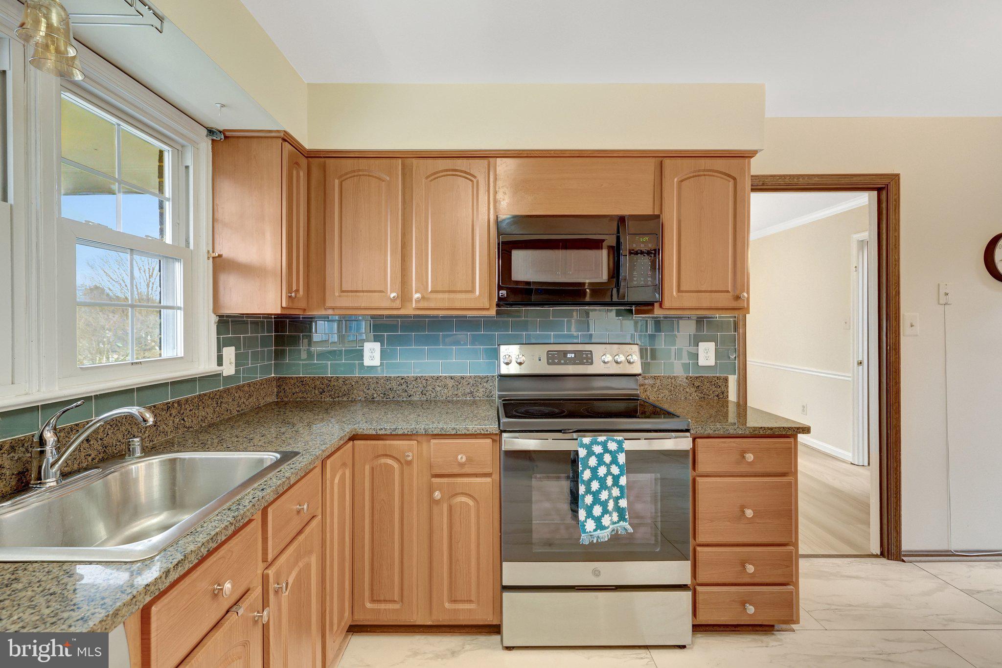 1398 Park Lake Drive Reston, VA 20190 - Photo 18 of 64 a kitchen with stainless steel appliances granite countertop a sink stove and microwave
