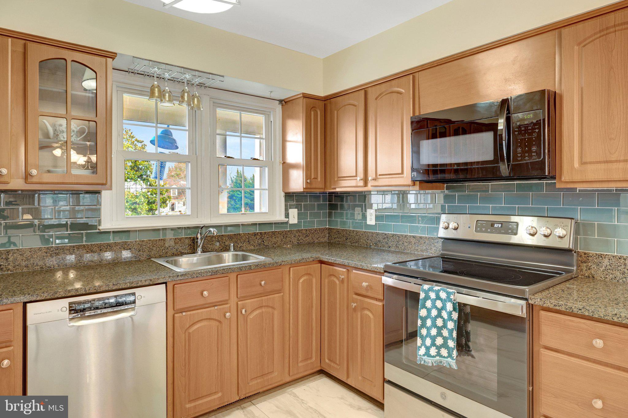 1398 Park Lake Drive Reston, VA 20190 - Photo 19 of 64 a kitchen with granite countertop a sink stainless steel appliances and cabinets