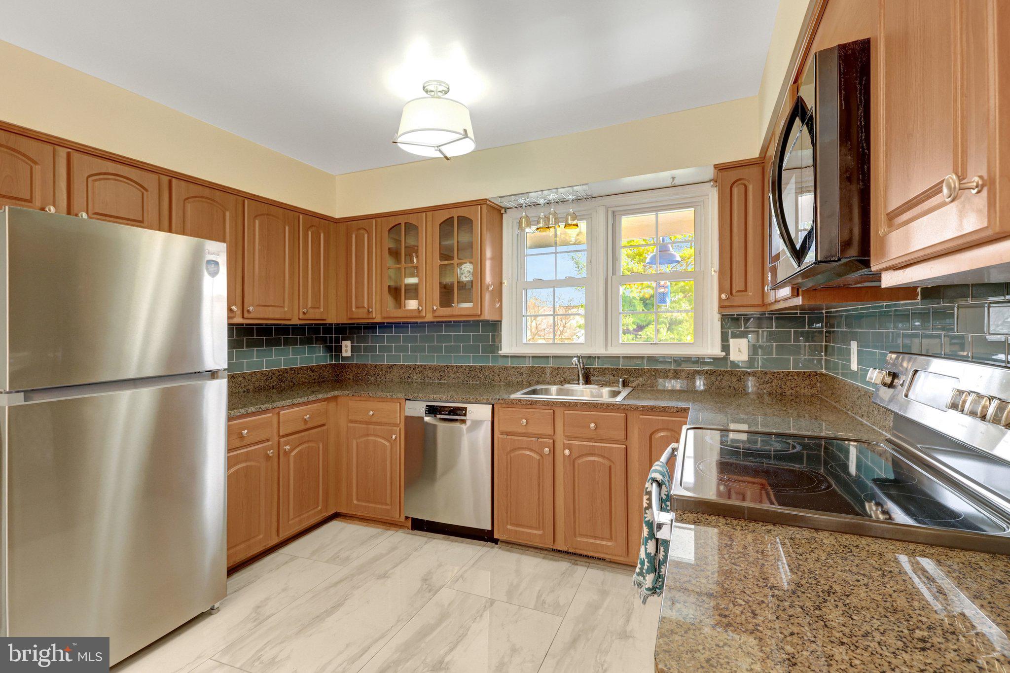 1398 Park Lake Drive Reston, VA 20190 - Photo 20 of 64 a kitchen with stainless steel appliances granite countertop a refrigerator a sink dishwasher a stove a sink and dishwasher with wooden floor