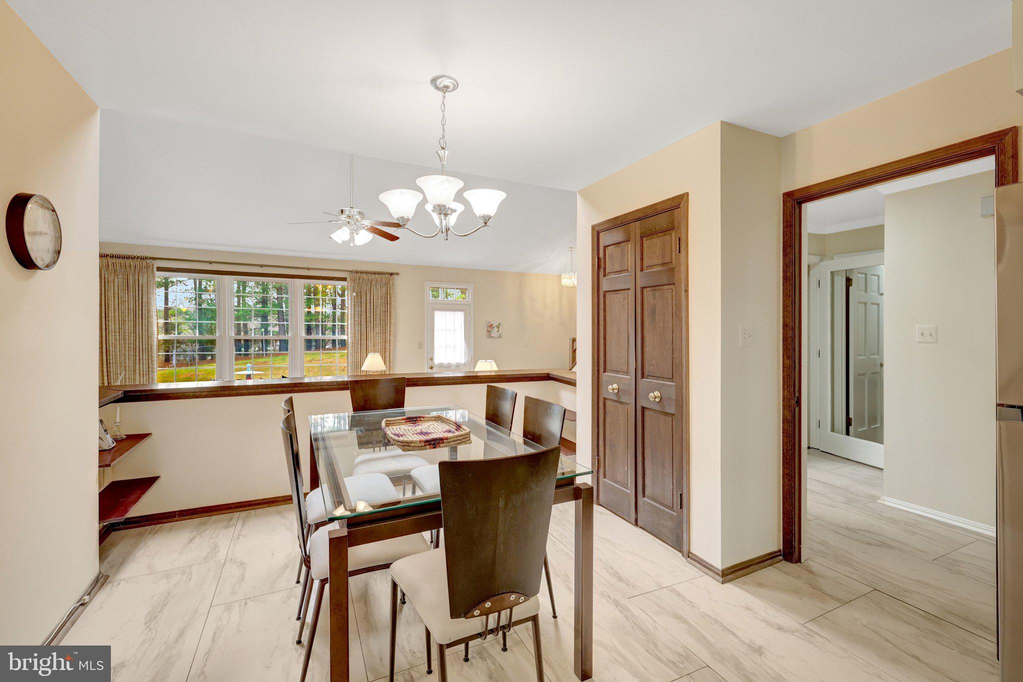 1398 Park Lake Drive Reston, VA 20190 - Photo 23 of 64 a view of a dining room with furniture wooden floor and chandelier