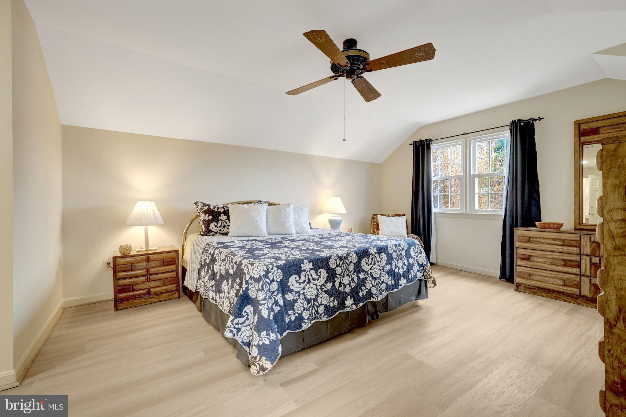 1398 Park Lake Drive Reston, VA 20190 - Photo 32 of 64 a bedroom with a bed a dresser and flowerpot