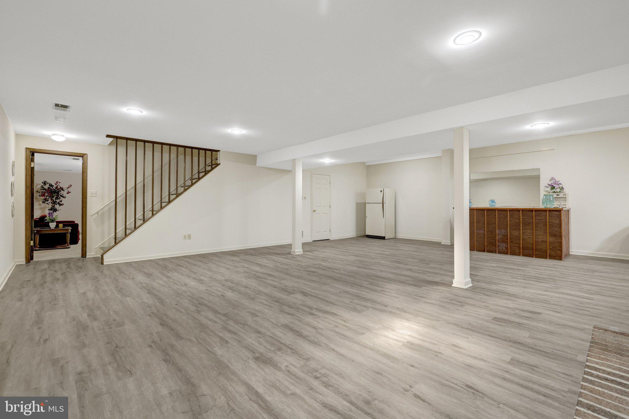 1398 Park Lake Drive Reston, VA 20190 - Photo 40 of 64 an empty room with wooden floor and stairs
