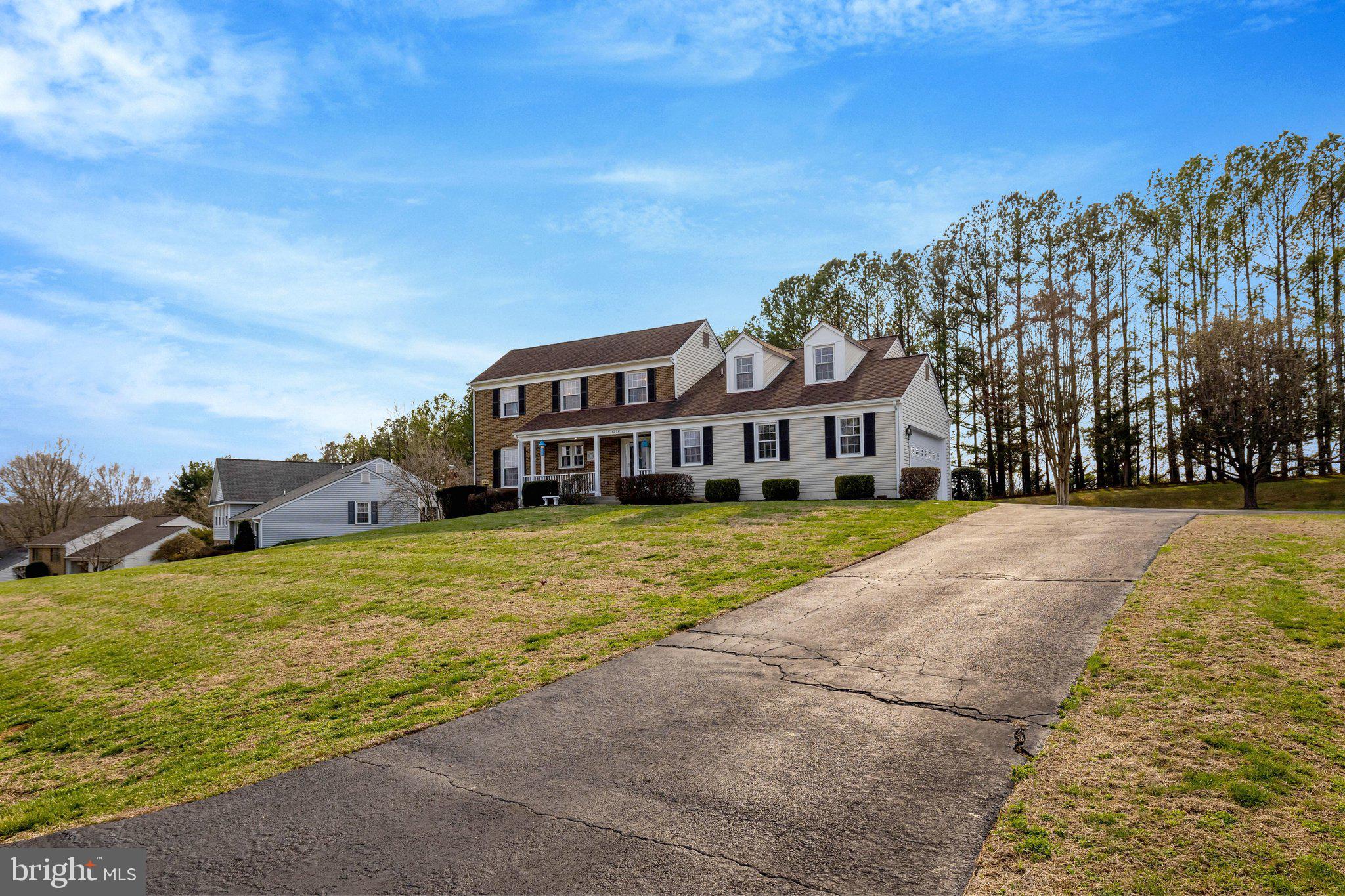 1398 Park Lake Drive Reston, VA 20190 - Photo 5 of 64 a view of a house with a big yard and large trees