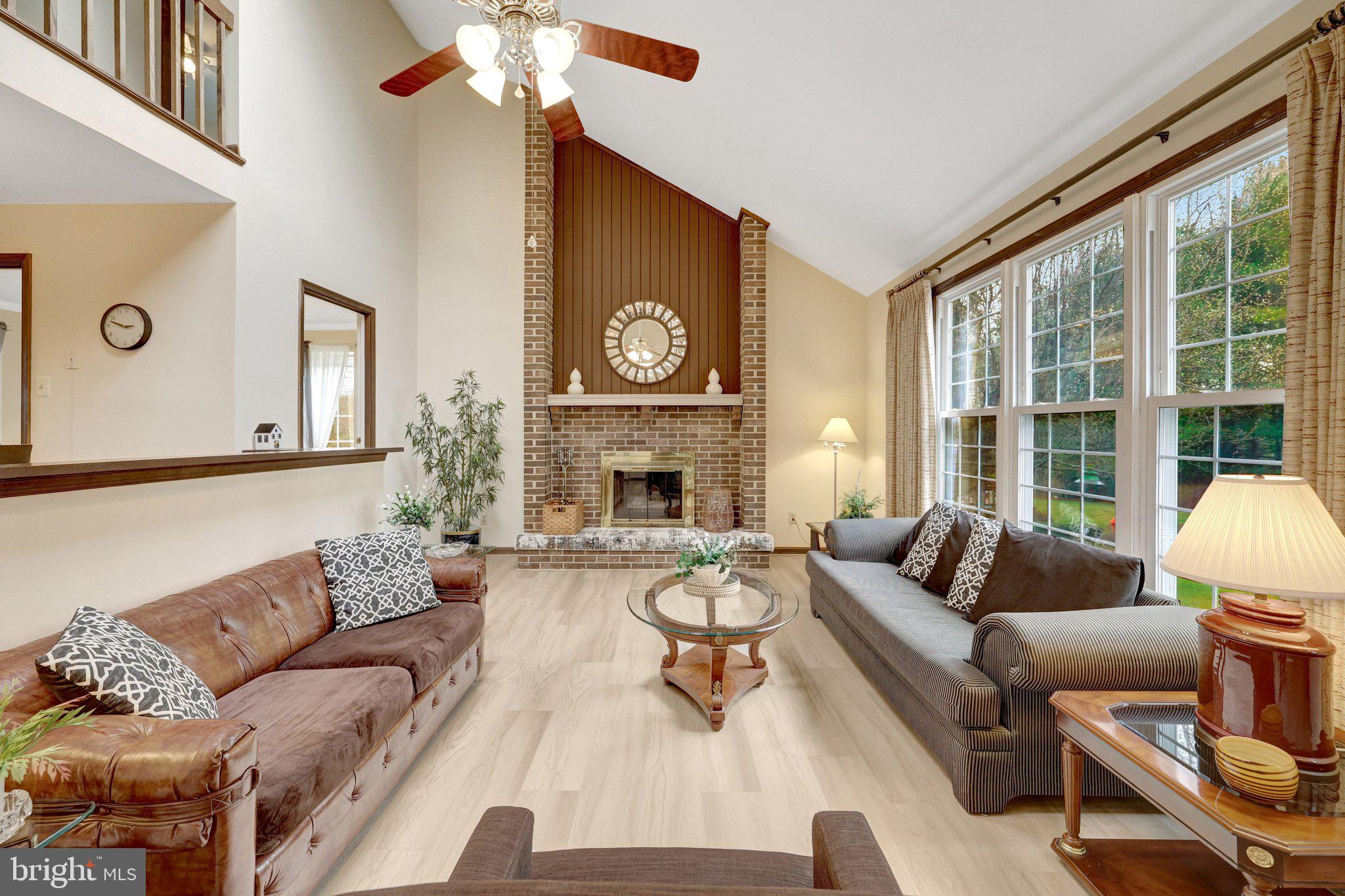1398 Park Lake Drive Reston, VA 20190 - Photo 10 of 64 a living room with furniture a fireplace and a large window