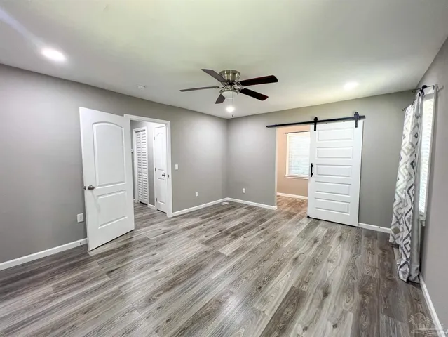 a view of a livingroom with a hardwood floor and a ceiling fan