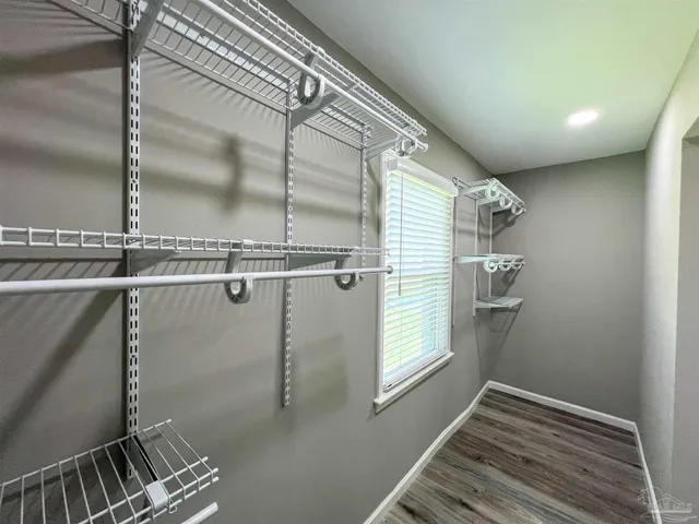 a view of a room with rack on the wall and a window