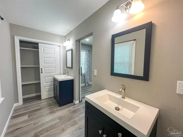 a bathroom with a sink vanity and a mirror