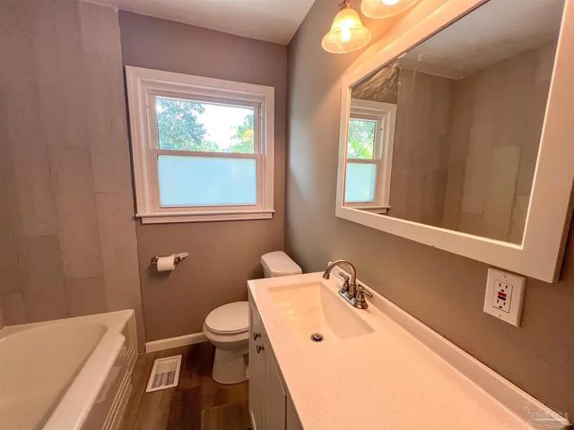 a bathroom with a sink a toilet and a bathtub