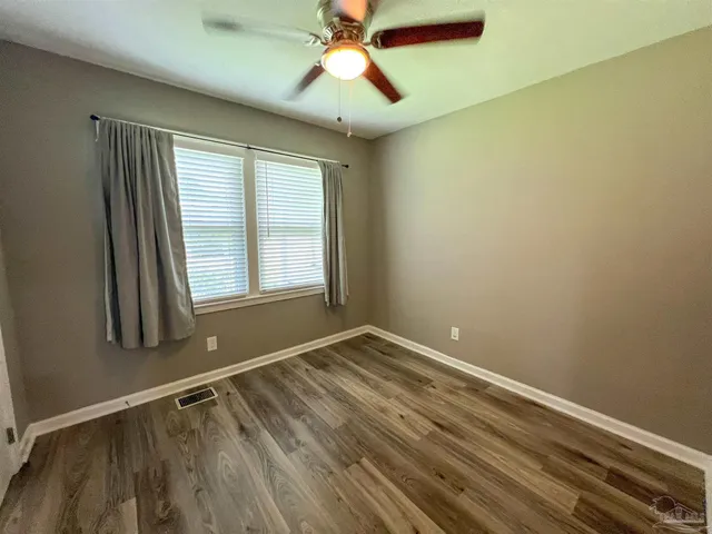 a view of room with window and ceiling fan