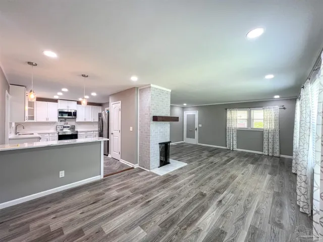 a view of kitchen and kitchen with wooden floor