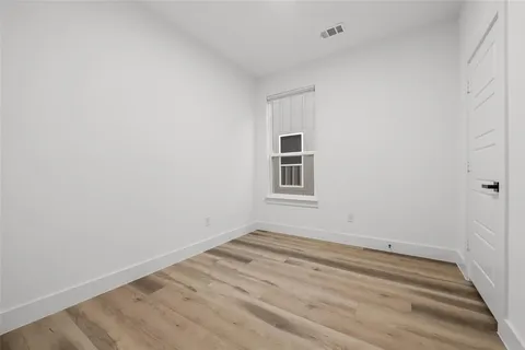 a bedroom with bed and a mirror