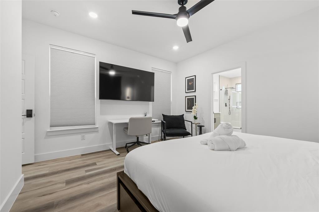 2701 Birmingham Avenue Dallas, TX 75215 - Photo 16 of 21 a bedroom with a bed and a flat screen tv