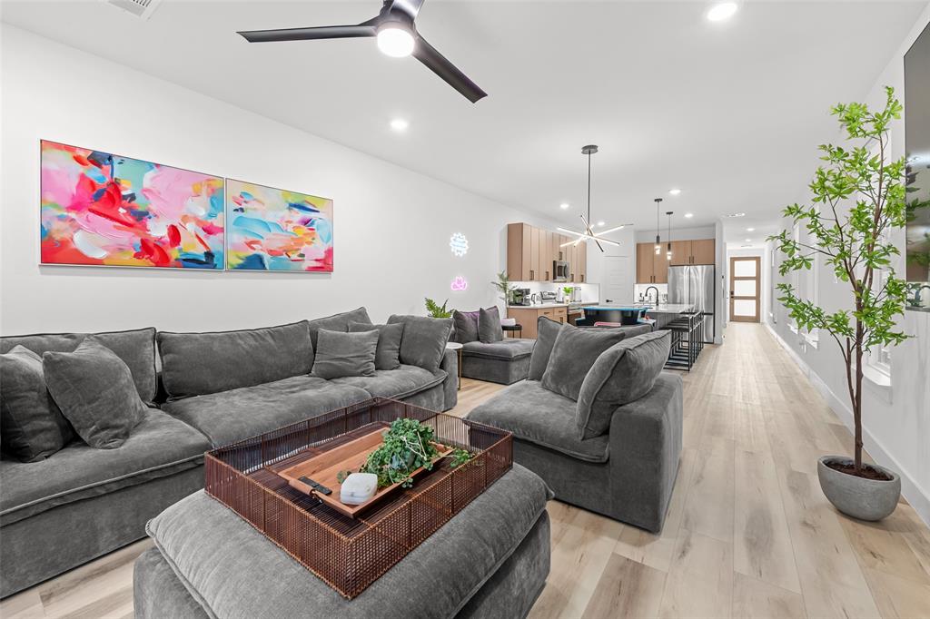2701 Birmingham Avenue Dallas, TX 75215 - Photo 6 of 21 a living room with furniture and a chandelier