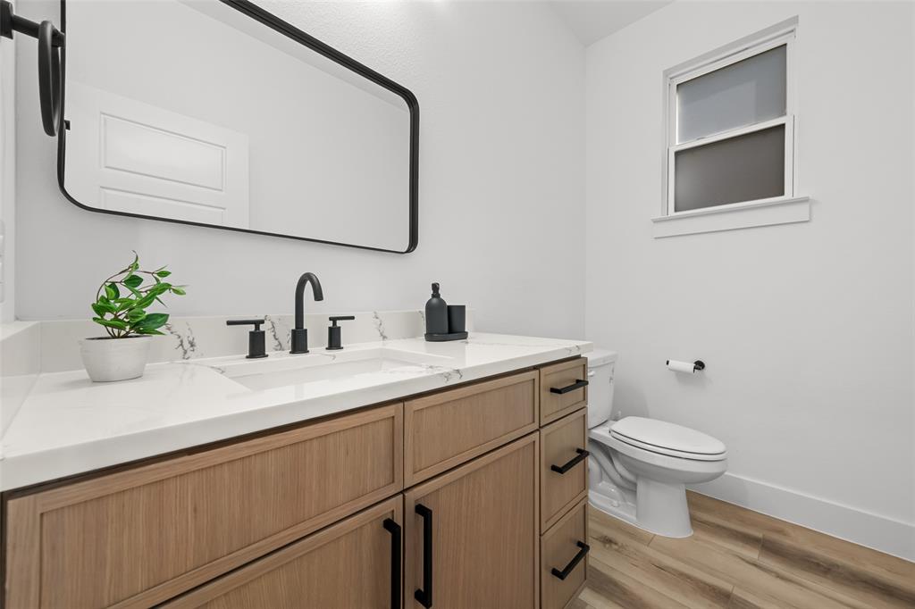 2701 Birmingham Avenue Dallas, TX 75215 - Photo 7 of 21 a bathroom with a sink toilet and a mirror