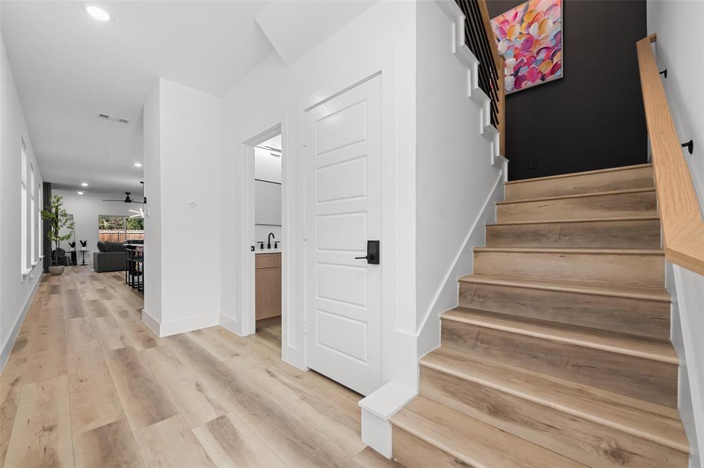 2701 Birmingham Avenue Dallas, TX 75215 - Photo 8 of 21 a view of a hallway to a house with wooden floor and stairs