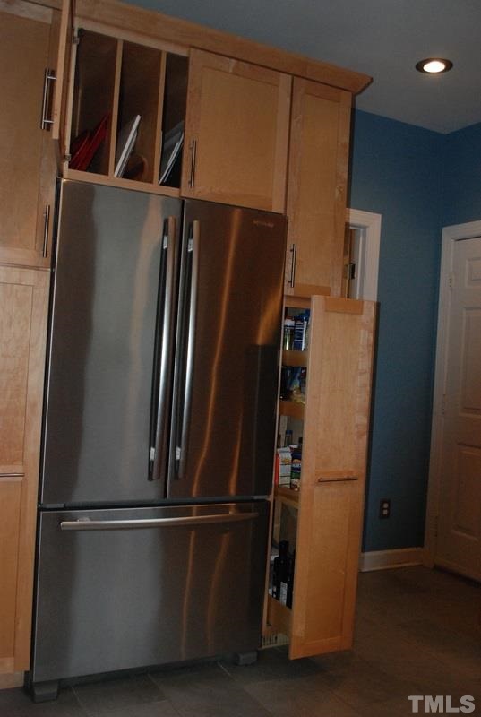 610 Manor Ridge Road Carrboro, NC 27510 - Photo 11 of 24 Custom cabinets make use of every bit of available space in this kitchen and the built-in stainless refrigerator conveys with the home.