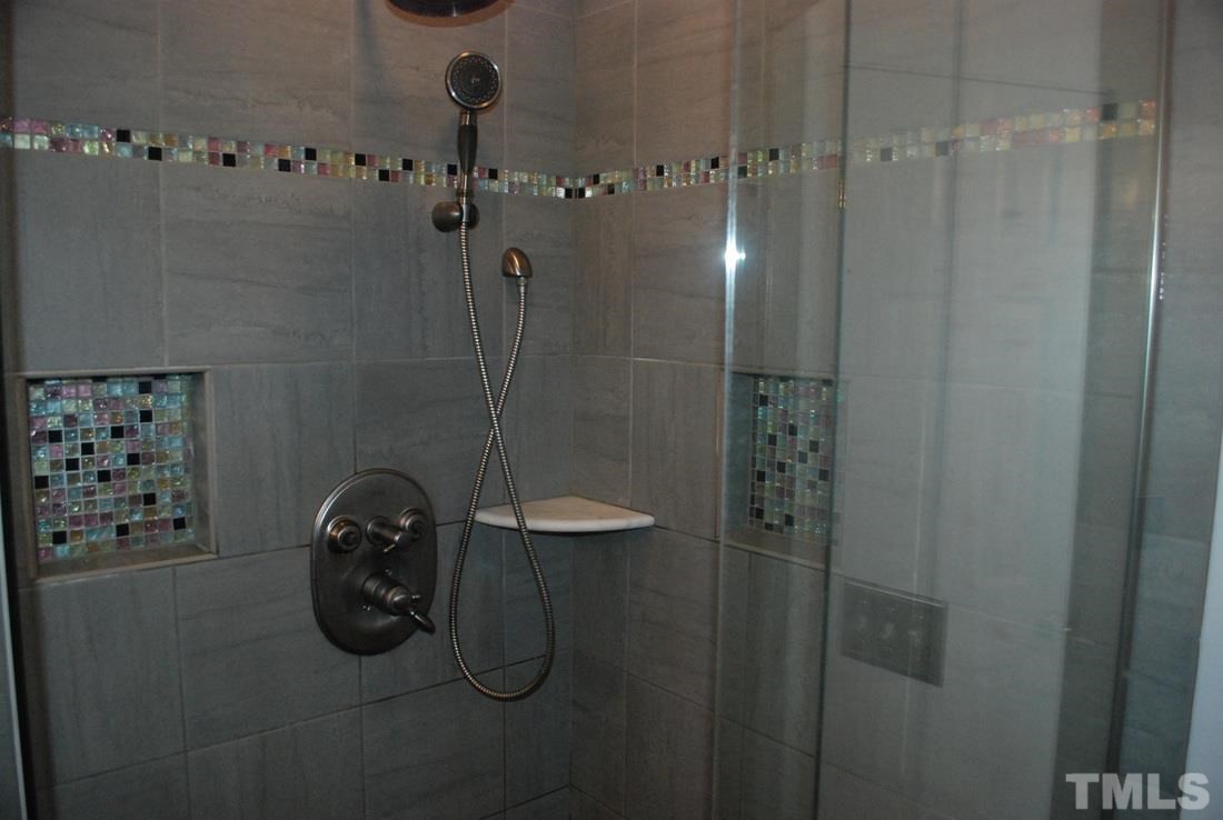 610 Manor Ridge Road Carrboro, NC 27510 - Photo 14 of 24 Beautifully tiled shower with body jets and raincan shower head is the perfect wakeup each morning.