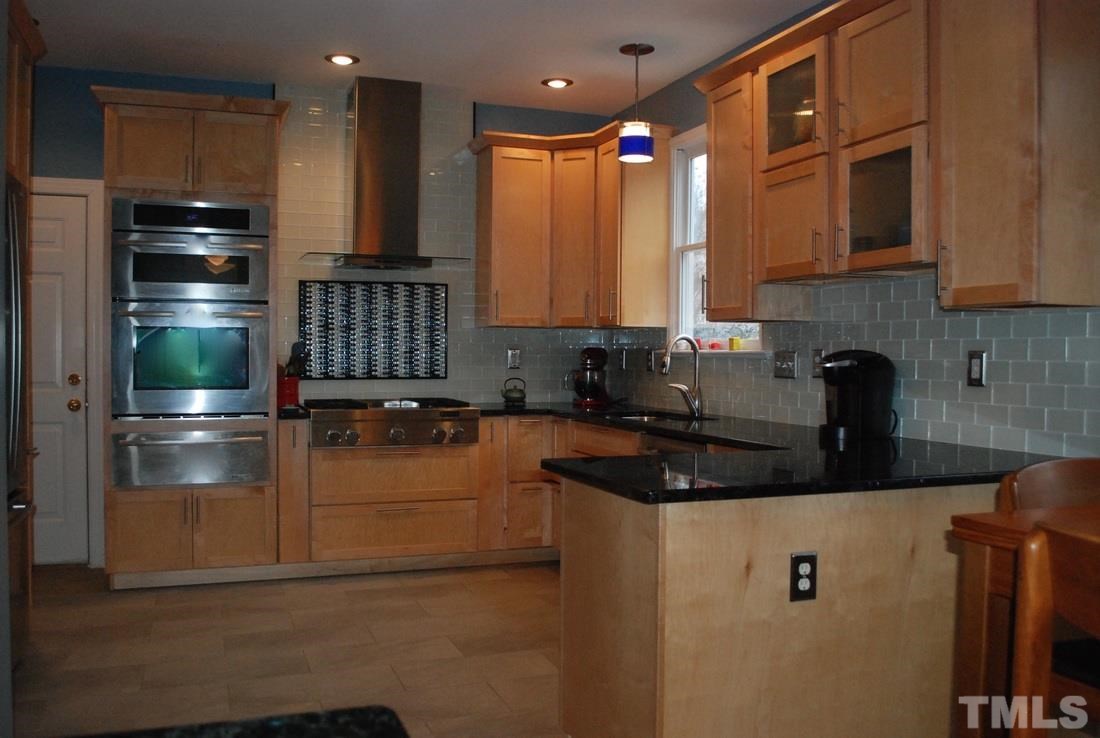 610 Manor Ridge Road Carrboro, NC 27510 - Photo 10 of 24 Spacious countertops and an island give this kitchen ample workspace.