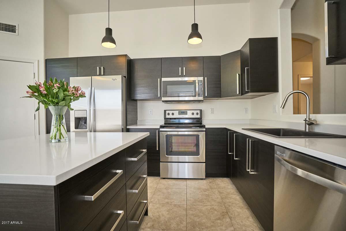 304 West Colt Road Tempe, AZ 85284 - Photo 2 of 28 a kitchen with a sink dishwasher a refrigerator and a stove