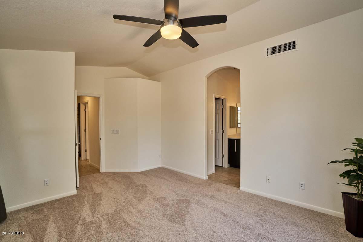 304 West Colt Road Tempe, AZ 85284 - Photo 22 of 28 an empty room with closet and a chandelier fan