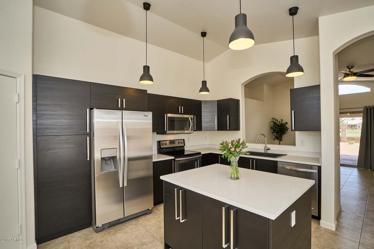 304 West Colt Road Tempe, AZ 85284 - Photo 3 of 28 a kitchen with a sink a counter top space stainless steel appliances and cabinets