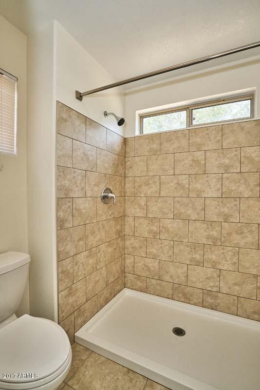 304 West Colt Road Tempe, AZ 85284 - Photo 7 of 28 a bathroom with a bathtub and a toilet