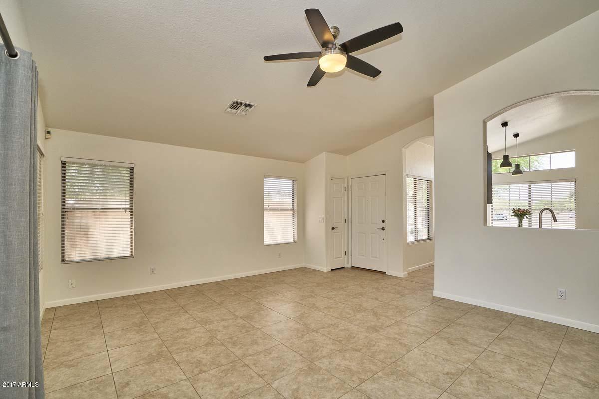 304 West Colt Road Tempe, AZ 85284 - Photo 9 of 28 a view of a livingroom with a ceiling fan and window