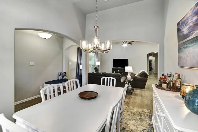 a view of a dining room with furniture and a chandelier