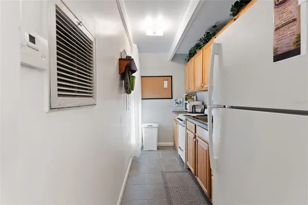 a kitchen with a refrigerator and a stove
