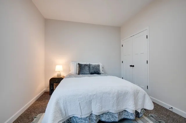 a bedroom with a bed and a night stand