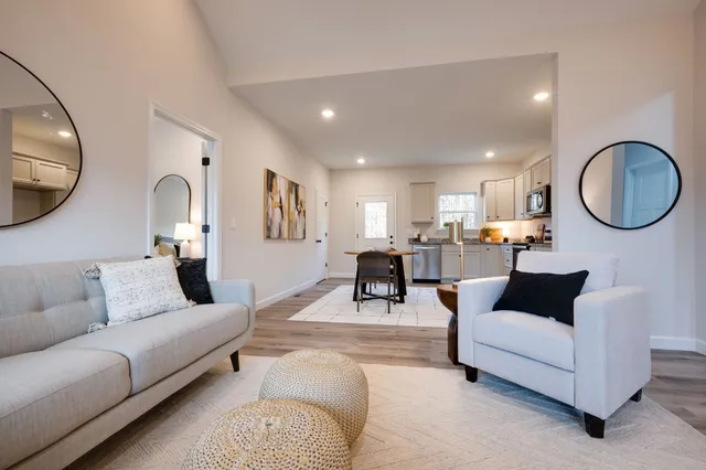 a living room with furniture and a mirror