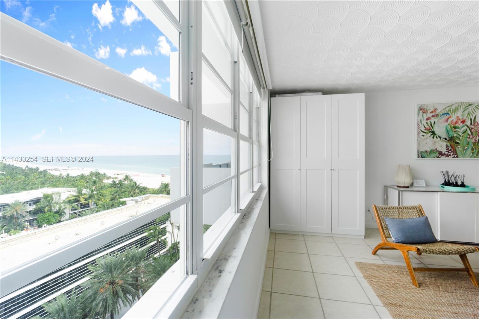 a view of a room with furniture and floor to ceiling window