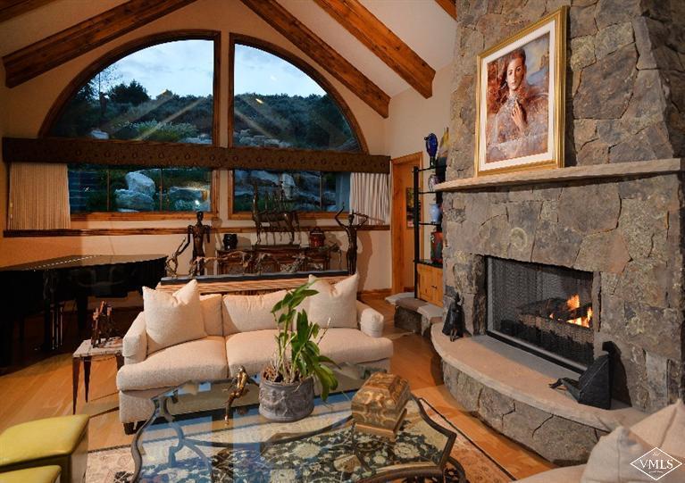 141 Mesquite Drive Edwards, CO 81632 - Photo 5 of 17 a living room with furniture a fireplace and a floor to ceiling window