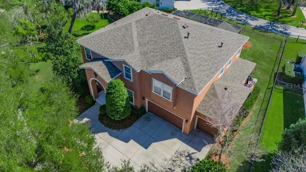 a aerial view of a house with a yard and potted plants