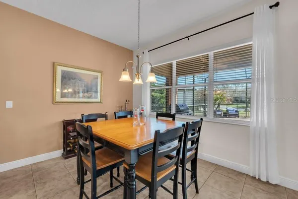 a kitchen with stainless steel appliances granite countertop a refrigerator a sink a stove and white cabinets with wooden floor